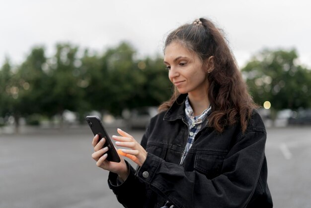 persona nella piattaforma di social media online che tiene il cellulare con lo smartphone all'aperto