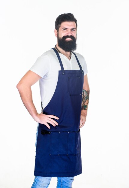 Personale del barbiere Salone per la cura della barba Barbiere macho ben curato Stile hipster Concetto di barbiere Parrucchiere barbiere per uomo Uomo brutale hipster barbuto con baffi indossare uniforme grembiule