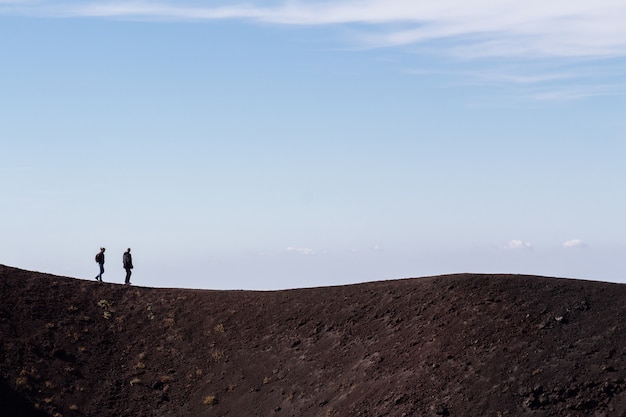 Persone che camminano lungo il vulcano Etna