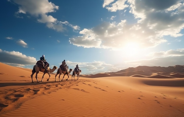 Persone che cavalcano cammelli su una duna di sabbia nel deserto