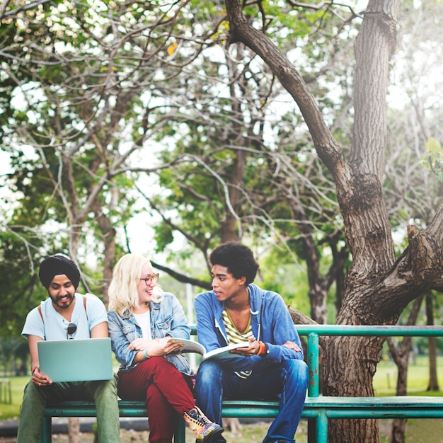 Persone che lavorano su un computer portatile nel parco