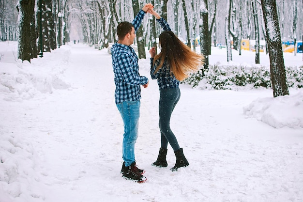 Persone, giovani coppie che camminano, ballano nel parco. Vacanze invernali in famiglia, stare insieme, data. Amore