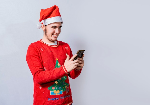 Persone in cappello di Babbo Natale utilizzando e sorridendo al cellulare isolato Giovane sorridente con cappello di Natale utilizzando il cellulare isolato Ragazzo felice con cappello di Natale sorridente al cellulare isolato