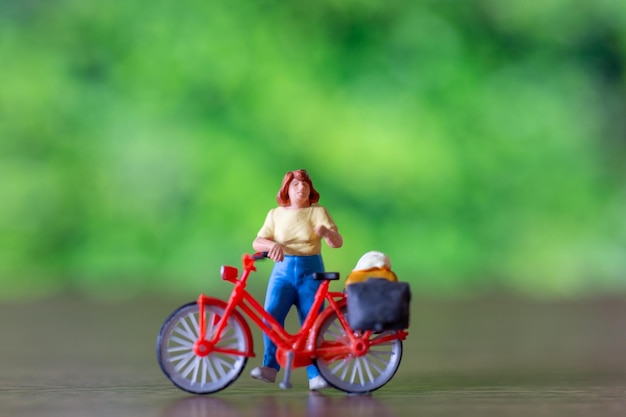 Persone in miniatura in piedi con la bici Giornata mondiale della bicicletta concetto