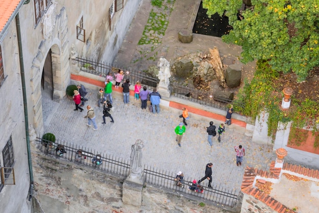 Persone sul ponte di pietra con statue nell'antico castello