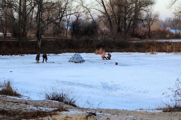 Pesca invernale su un fiume ghiacciato Dnepr