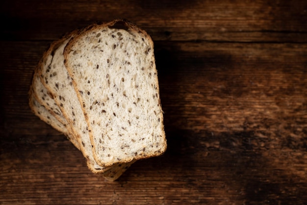 Pezzi di pane con semi su uno sfondo di legno Pane sano sano Cibo sano Posto per il testo