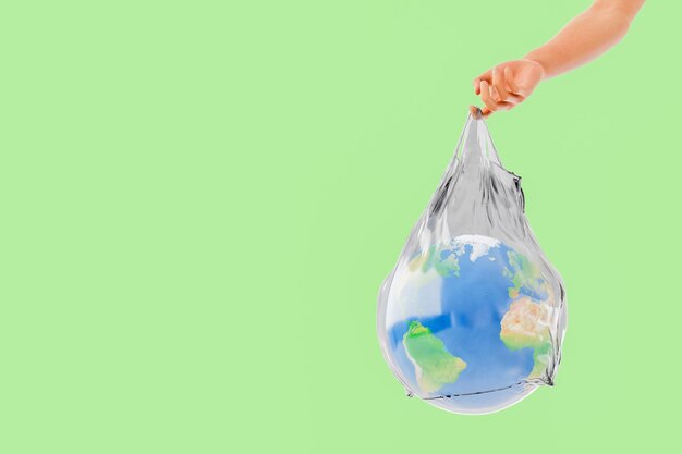 pianeta terra all'interno di un sacchetto di plastica tenuto da una mano