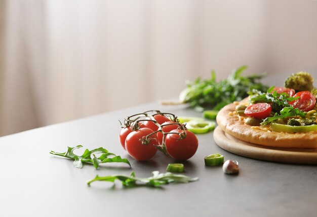 Piastra con gustosa pizza vegetariana sul tavolo