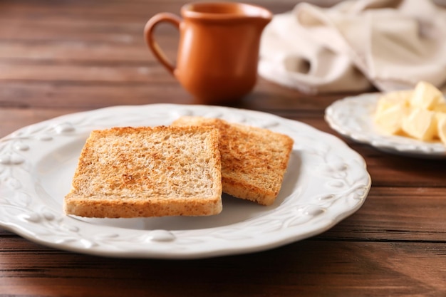 Piastra con gustoso pane tostato sulla tavola di legno