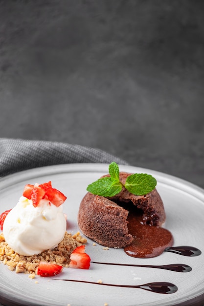 Piatto bianco con torta al cioccolato fondente con gelato