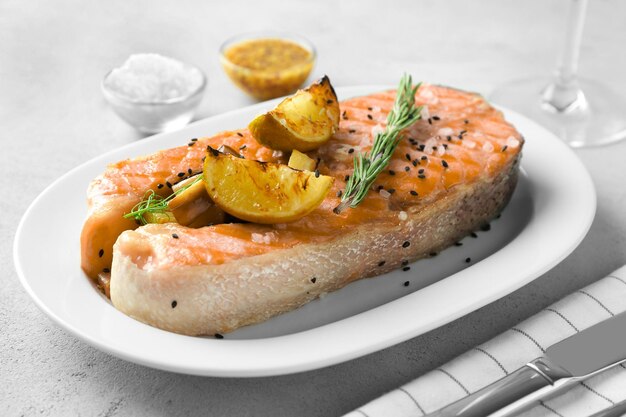 Piatto con deliziosa bistecca di salmone sul tavolo