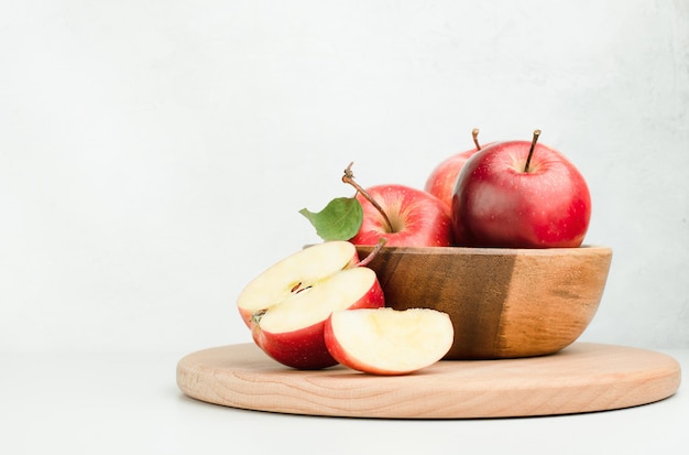 Piatto di legno con mele rosse fresche