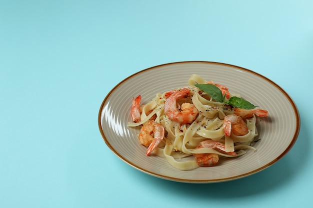 Piatto di pasta saporita di gamberetti sul blu