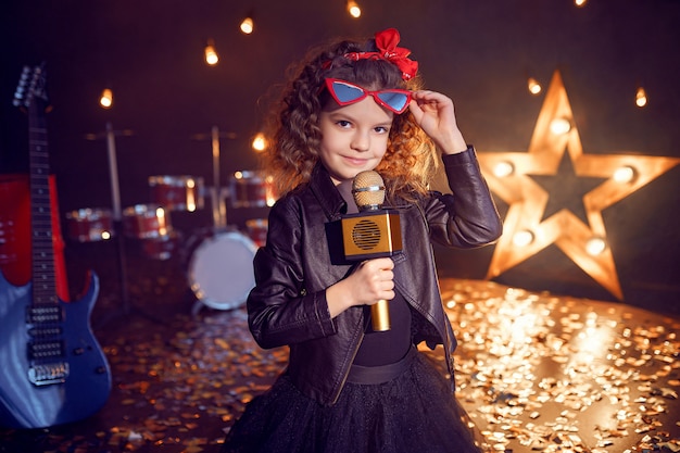 Piccola bella ragazza che canta nello studio di registrazione