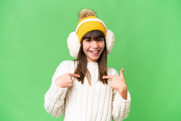 Piccola ragazza caucasica che indossa manicotti invernali su sfondo isolato con espressione facciale a sorpresa
