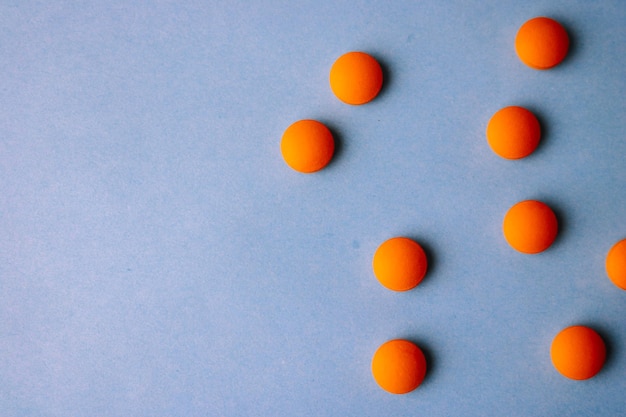Piccole pillole rotonde farmaceutiche mediche giallo arancio belle vitamine farmaci antibiotici