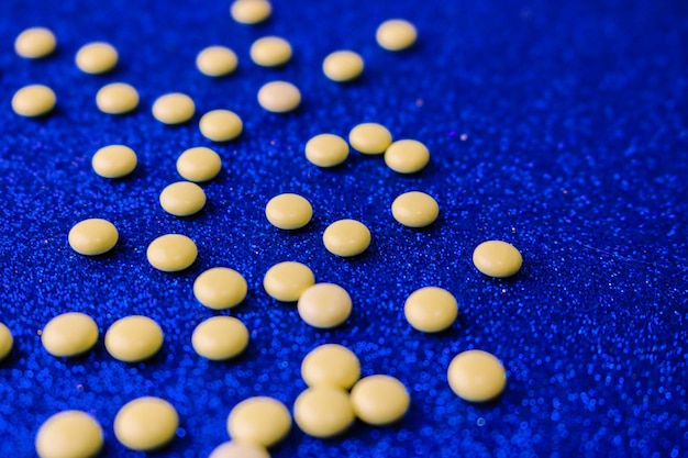 Piccole pillole rotonde farmaceutiche mediche giallo arancio belle vitamine farmaci antibiotici
