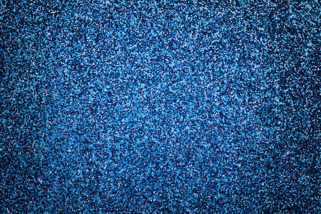 Piccoli paillettes scintillanti dei blu navy, primo piano. Sfondo brillante.