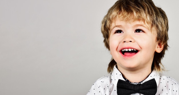 Piccolo ragazzo sorridente felice infanzia positivo bambino closeup ritratto alla moda bambino piccolo in bianco