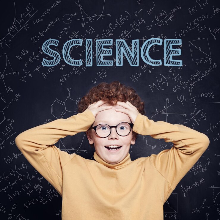 Foto piccolo studente felice contro la lavagna con formule di scienza e matematica