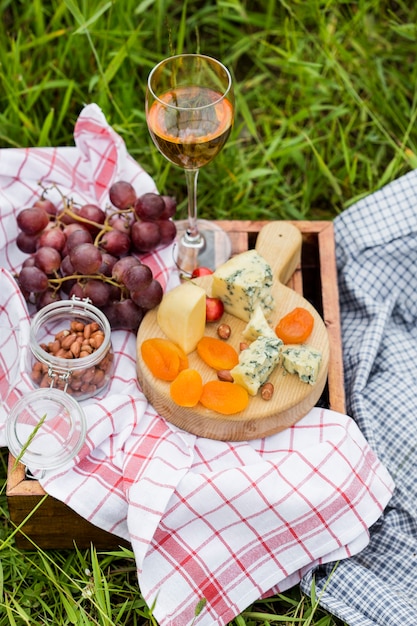 Picnic al parco sull'erba: vino, formaggio e pane