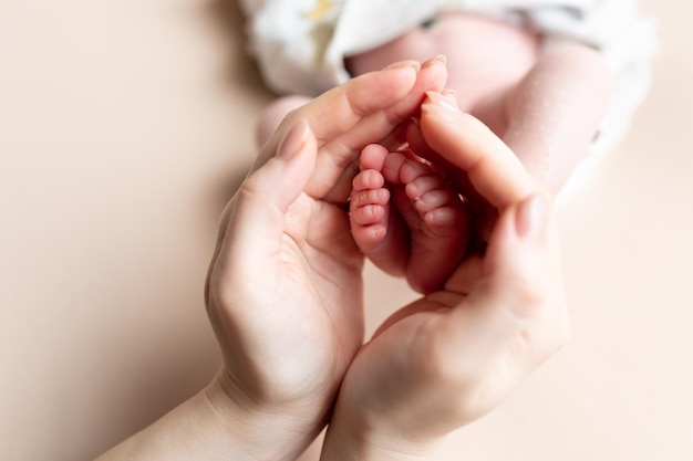 piedi del bambino nelle mani della madre