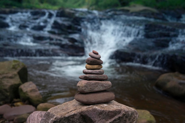 pietre in equilibrio zen con cascata sullo sfondo