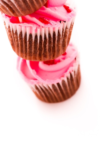 Pila di cupcakes rosa su sfondo bianco.