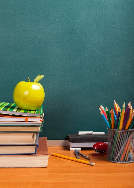 Pila di libri colorati e mela fresca