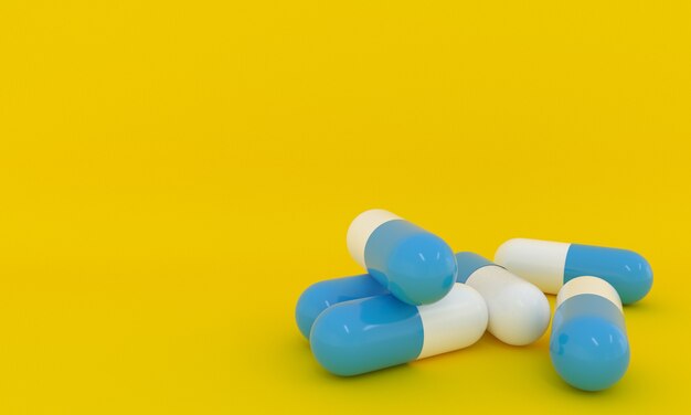 Pillole blu e bianche impilate da vicino su sfondo giallo