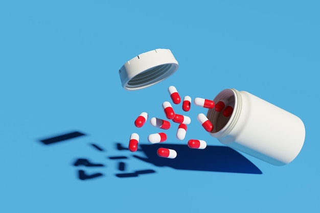 Pillole rosse un bianco che si rovesciano dalla bottiglia della pillola isolata su priorità bassa blu.