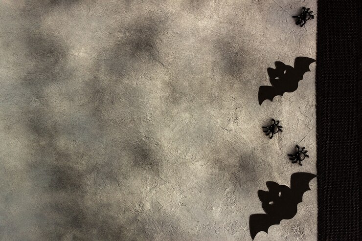 Pipistrelli e ragni di carta nera su sfondo grigio, design moderno e minimale, carta di halloween.