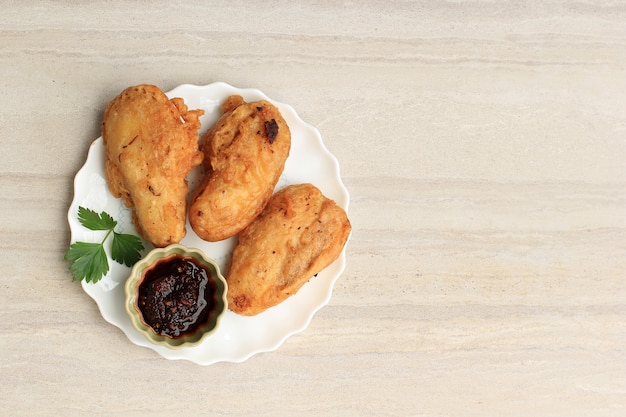 Pisang Goreng Sambal Roa o banana fritta con Sambal Roa è una delle tipiche delizie culinarie di Manado Indonesia, vista dall'alto su sfondo di marmo