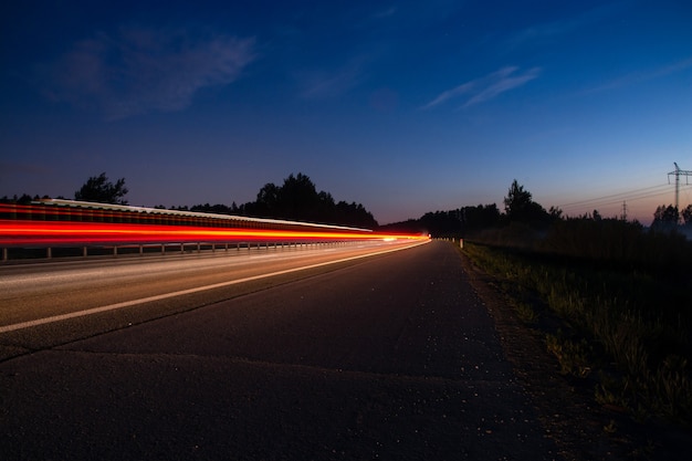 Pista notturna con luci sfocate dai fari delle auto. Tempo di esposizione lungo.