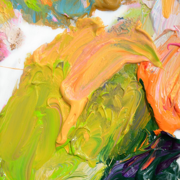 Pittura ad olio colorata di diversi colori su una tavolozza su sfondo bianco