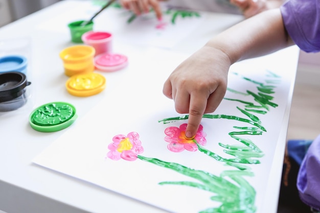 Pittura con le dita Primo piano Dita delle mani dei bambini in vernice brillante Sviluppo iniziale Hobby