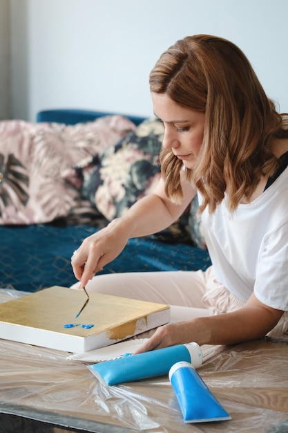 Pittura dell'artista con spatola e colori acrilici in primo piano mano studio