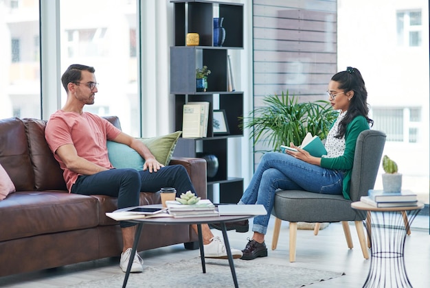 Più parliamo e più capiamo Inquadratura di un giovane uomo e una donna che discutono in un ufficio moderno