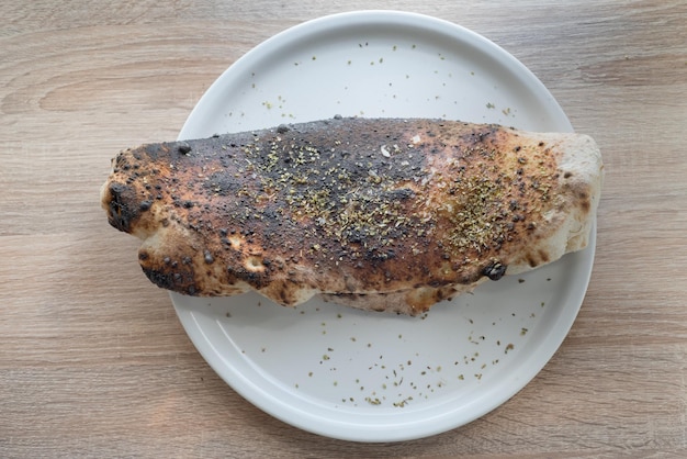 Pizza calzone su un piatto da un forno napoletano cucina tradizionale italiana casalinga