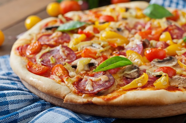 Pizza con salame, pomodoro, formaggio e funghi