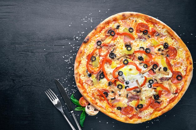 Pizza con verdure. Su uno sfondo di legno. Vista dall'alto. Spazio libero per il tuo testo.