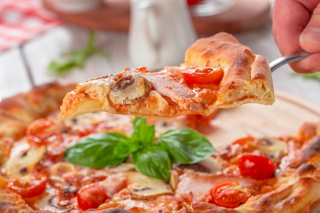 Pizza fresca deliziosa servita sulla tavola di legno