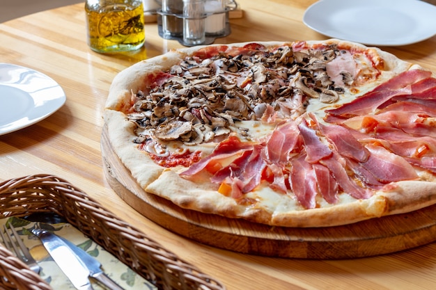 Pizza italiana con funghi e prosciutto di Parma