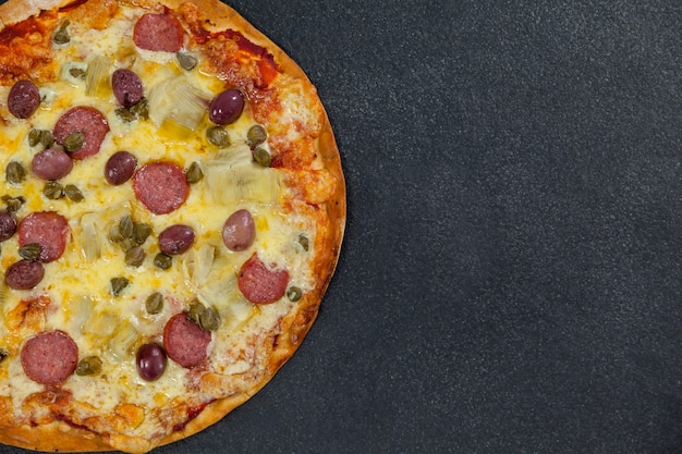 Pizza italiana deliziosa servita su sfondo grigio