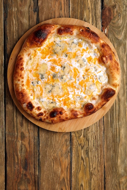 Pizza italiana Quattro formaggi Pizza italiana su tavola di legno sullo sfondo