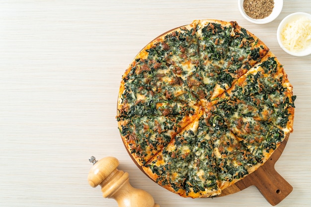 pizza spinaci e formaggio su vassoio di legno - stile vegano e vegetariano