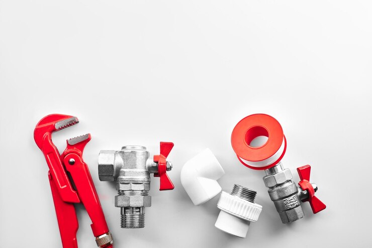 Plumbing tools and equipment on a white background closeup with copy space