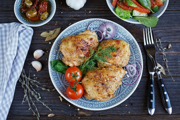 Pollo arrosto e verdure su fondo in legno