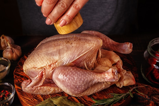 Pollo crudo sul tagliere di legno